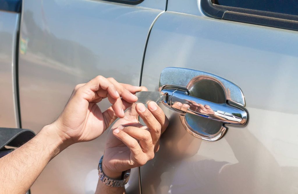Locksmith Vaughan expert unlocking a car door using specialized tools during an emergency lockout service.