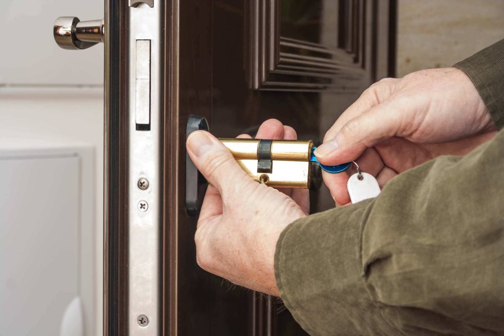 Lock repair service in Aurora – Professional locksmith replacing a door lock for enhanced security.