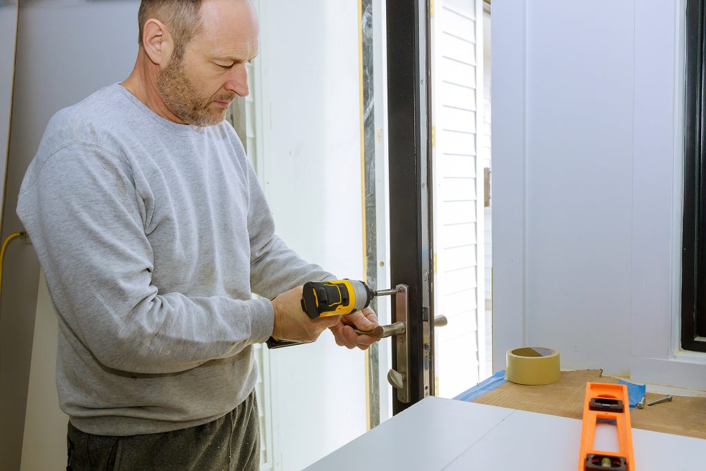 Closeup Of A Professional Locksmith Installing Or Repairing A Ne